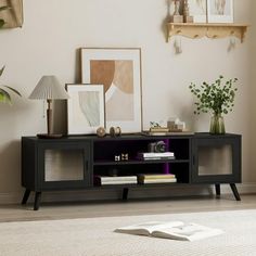 a living room with a book shelf and pictures on the wall above it, along with other decor items