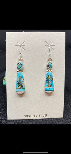 These Beautiful Earrings are micro-inlayed with Kingsman Turquoise and White Opal into genuine Sterling Silver! The intricate work is stunning in person and the earrings speak for themselves! Length: 1.25 Inches Width: .3 Inches Stones: Kingman Turquoise, White Opal Aztec Earrings, White Opal Earrings, Popular Earrings, Arizona Turquoise, Handmade Jewelry Gift, Kingman Turquoise, Opal Earrings, Coral Turquoise, White Opal