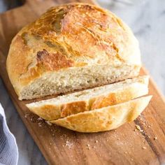 a loaf of bread sitting on top of a wooden cutting board