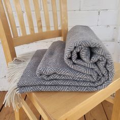 two blankets folded on top of a wooden chair