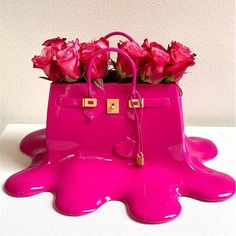 a pink handbag with flowers in it