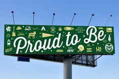 a sign that says proud to be on top of a pole