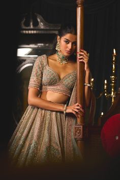 Step into refined elegance with the tavus lehenga set, a canvas of pastel dreams that weaves a tale of celebration. Crafted on organza, this lehenga beautifully merges rich tradition with modern aesthetics, showcasing exquisite resham thread embroidery, sequins, and cut dana that depict dancing peacocks. The blouse features luxurious embroidery on net organza, adding a touch of refinement, and is paired with a delicate net dupatta. Each piece is a masterpiece, meticulously crafted to capture the Karisma Kapoor, Anamika Khanna, Sonakshi Sinha, Sara Ali Khan, Diana Penty, Green Lehenga, Peacock Pattern, Kareena Kapoor Khan, Madhuri Dixit