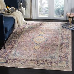 a living room filled with furniture and a large rug