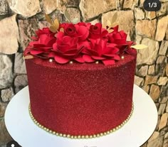 there is a red cake with flowers on it