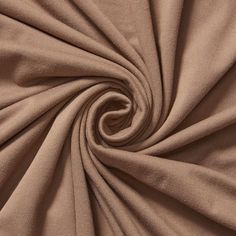 a close up view of the fabric on a plain tan colored cloth, with very thin folds