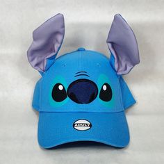 New To Poshmark? Sign Up And Use The Code: Disneyandmore To Get $10 Off Your First Purchase! Condition: New Size: Adjustable With Hook & Loop Strap / One Size Fits All Color: "Stitch" Blue Material: 100% Cotton This Disney Character Hat Looks Just Like The Fan Favorite Alien From Disney's 2002 Lilo And Stitch Movie. The Stitch Baseball Hat Includes 3d Ears, Printed Eyes And An Embroidered Nose Details. This Hat Is Perfect To Wear For A Day At Disney Theme Parks Or For Wearing When Your With Your Lilo And Stitch Movie, Stitch Movie, Stitch Hat, Stitch Blue, Hat Patches, Disney Character, Disney Theme Parks, Disney Lilo, Disney Theme