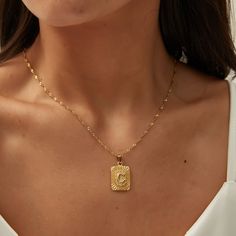 DESCRIPTION & DETAILS An elegant handmade square initial necklace and suspended on a beautiful chain. This necklace is perfect for the woman who likes to be a little edgy. The most beautiful and modern initial necklace you'll find. Classic and perfect for layering for leaving it all alone. Plating: 14k Gold Materials: 14K Gold on Stainless Steel Measurements: 40 + 5 cm Hypoallergenic SUSTAINABILITYIn-house plating - All pieces are hand crafted by our in-house jewellers ensuring a high standard o Gold Square Pendant Necklace, Square Necklace, Letter Pendant Necklace, Gold Letter, All Alone, Square Pendant, Letter Necklace, Recycled Sterling Silver, Initial Necklace