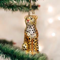 a leopard ornament hanging from a christmas tree