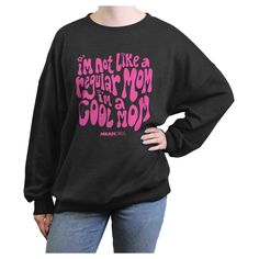 You can't sit with us... unless you're wearing a cool officially licensed Mean Girls I'm Not a Regular Mom Groovy Juniors' Graphic Oversized Sweatshirt! This fun pullover reads the iconic quote from the film: "I'm Not Like a Regular Mom I'm a Cool Mom" in cute groovy lettering across the front, and the classic movie logo in matching pink below. Shop this new Mean Girls apparel this Mother's Day and make mom laugh with her favorite characters, popular quotes, hilarious moments, and more. Pop Culture Slogan Tops With Relaxed Fit, Cool Crew Neck Tops For Winter, Relaxed Fit Slogan Tops For Pop Culture, Cool Cotton Winter Tops, Cool Cotton Tops For Winter, Cool Sweatshirt With Letter Print, Oversized Black Top With Lettering, Cool Long Sleeve Relaxed Fit Tops, Cool Relaxed Fit Long Sleeve Tops