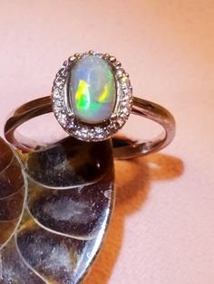 1ct Australian lightning ridge opal, surounded by CZ size 7, 925 silver 4 prong ring. Simple yet beautiful, going fast as I can make em. Silver Opal Ring With Halo, Engagement Ring Opal, Opal Wedding Band, Australian Opal Ring, Prong Ring, Opal Engagement Ring, Opal Wedding, Lightning Ridge Opal, Ring Opal