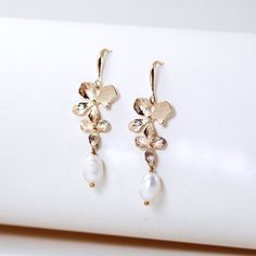 orchid flower pearl bridal earrings Gold Pearl Flower Bridal Earrings, Gold Plated Flower Charm Earrings For Wedding, White Gold Plated Flower Earrings For Wedding, Floral Pearl Charm Earrings For Wedding, Wedding Flower Dangle Earrings In Gold Plated, Gold Plated Dangle Flower Earrings For Wedding, Delicate Pearl Drop Earrings With Flower Shape, Delicate Pearl Drop Earrings In Flower Shape, Delicate Flower Shape Pearl Drop Earrings