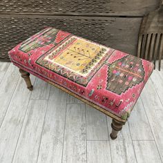 a bench with a colorful rug on top of it