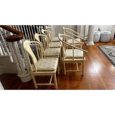 six chairs sitting on top of a wooden floor next to a banister and railing