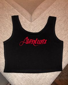 Super cute Aventura crop top Primary color is for the letters color ! 🤍 ** DISCLAIMER  shirts have a snug fit so if in doubt size up ! ** 😊 Aventura Concert Outfit 2024, Casual Black Crop Top For Music Festival, Black Casual Crop Top For Music Festival, Casual Crop Top For Music Festival, Casual Crop Top With Graphic Print For Concerts, Sporty Logo Print Crop Top For Streetwear, Casual Letter Print Top For Music Festival, Fitted Logo Print Casual Crop Top, Casual Crop Top Tank For Streetwear