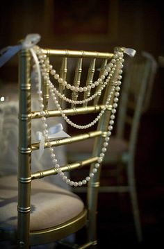 the back of a chair with pearls on it