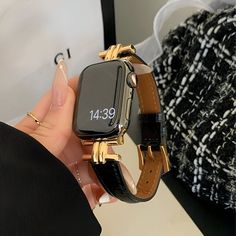 a person holding an apple watch in their hand