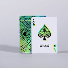 a green and blue playing card with the word glitton 20 on it's side