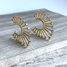 New ~ Anthropologie Gold Sunburst Crystal Tip Hoop Earrings Light Shines Brightly From These Stylish Sunburst Hoops. Each Spike Is Studded With A Glass Crystal For Optimum Shine! Bold In Style, Yet Light In Weight. Gold-Plated, Glass Crystals. Earring Stud Backs Included. Approx. Size: 1-1/4"L, 1/8"W. Nwot. Anthro Style, Boho Style, Trendy, Brand New Anthropologie Jewelry, Everyday Hoop Earrings, Gold Hoops, Star, Sun, Moon, Celestial, Goddess, Starburst, Spike Hoops, Art Deco, Diamond, Crystal, Celestial Goddess, Anthro Style, Earrings Gold Hoops, Crystal Spikes, Jewelry Everyday, Anthropologie Jewelry Earrings, Gold Sunburst, Gold Hair Clips, Boho Crystal