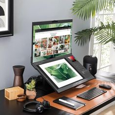 a laptop computer sitting on top of a wooden desk