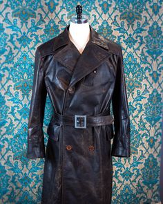 This piece, made from American pullup horsehide, is based on a WWI-era aviator's coat with rainflaps that snap down over the front closure, a convertible collar, a dispatch chest pocket, and a cathedral back. The aniline hides take on a beautiful distresses texture over time which can be accentuated or polished out, depending on your preference. The buttons are luxurious corozo nut and the inner liner is made from cotton moleskin. American history----but made new---in your size----and better than any real military coat ever was. ------------------------ Everything is completely custom and handmade.  The pricing above is for a (very complicated!) jacket with a comparable level of detail and number of pockets, but contact us before ordering to discuss all options and to get a quote on your c Brown Leather Military Outerwear, Brown Leather Hunting Outerwear, Steampunk Top, Leather Flight Jacket, Steampunk Top Hat, Convertible Collar, Military Coat, Car Coat, Distressed Texture