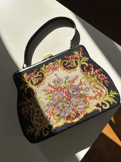 Vintage Gobelin Embroidered Bag / 50s style bag / Flower embroidery / Black traditional bag / Tapestry Handbag Vintage condition level: very good condition  Width: 32 cm  Height: 25 cm  Depth: 6 cm  Every item is vintage, pre-used, pre-loved, one-of-a-kind.   If you have any questions, please contact us before purchase. Irregularities or signs of wear might be present.  Visit our shop:  https://www.etsy.com/shop/DiscothequeClothing Let's keep in touch! Follow us on Instagram! IG: le_disc0theque Elegant Black Bags With Floral Print, Elegant Embroidered Top Handle Satchel, Rectangular Floral Print Shoulder Bag For Evening, Black Embroidered Formal Bag, Formal Embroidered Top Handle Shoulder Bag, Formal Black Embroidered Bag, Retro Embroidered Evening Bags, Evening Bag With Multicolor Embroidery, Rectangular Shape, Elegant Satchel Shoulder Bag With Floral Embroidery