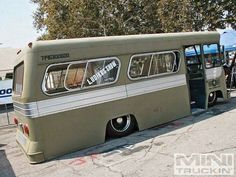 an old bus is parked on the side of the road