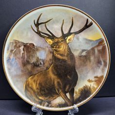 a plate with an image of a deer in the wilderness on it's side