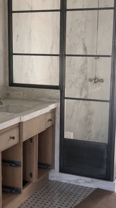 the bathroom is clean and ready to be used as a walk in shower with glass doors