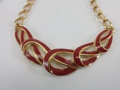 Trifari necklace in red enamel, 1980's. This Trifari piece features open, woven wide elongated links that lap over each other with red enamel interiors, outlined in smooth finished gold tone. The fused center design measures 3 1/2 inches long across the swag and the red enameled links are 3/4 inch tall. The wearable opening is 16 inches. This gold finish piece is in gorgeous condition. Signed. E2 Fast Holiday Shipping! Shipping is same or next day so you get your purchase fast. (Except Sundays). Gold Bride Jewelry, Vintage Trifari, Enamel Necklaces, Necklace Red, Necklace Statement, White Jewelry, White Gifts, Bride Jewellery, Chain Ring