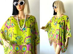 "♥ Y2k Flowy, lightweight, fluttery tunic style slouchy top by NT BY AMATI. ♥ Soft, stretch interior tank top and semi-sheer outer layer. ♥ Asymmetrical hem. ♥ Great bright lime green shade with teal, pink, black, yellow floral print. ♥ Lots of vacation vibes, great for resorts, beaches, poolside, summer parties! ♥ Fast FREE Shipping! ♥ Ask for a discount on bundles.  ♥ INSTAGRAM: franzialux_rellickroad MEASUREMENTS (FLAT)  * PIT TO PIT: 21\" (across)  Measured interior tank top. * TOTAL LENGTH: 25\"   - 35\" asymmetrical hem. *FIT / SIZE: Works great on a range of sizes! Small, Medium, Large and XL.-- (Shown on Betty 😇 a U.S. Size Small) *MATERIAL: Silk, Viscose *CONDITION: Excellent *BRAND:   NT by Amati PLEASE NOTE: All items are gently used to pristine. I hand-wash or gently cycle gar Summer Beach Cover-up Flowy Blouse, Green Vibrant Print Summer Blouse, Summer Blouse With Vibrant Green Print, Summer Green Blouse With Vibrant Print, Vibrant Summer Beach Blouse, Bohemian Summer Tunic With Vibrant Print, Green Hippie Tops For Vacation, Bohemian Spring Tunic Blouse, Summer Vacation Batwing Sleeve Top