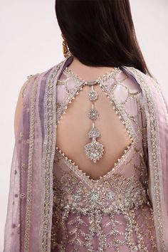 Luxury Lilac Embroidered Pakistani Wedding Dress in Frock Sharara Style is a stunning masterpiece in premium quality fabric, adorned with luxury designs and embroidery work. Hand-crafted details and embellishments make this stunning Pishwas Dress your priority for the big day. Pishwas Frock: The Traditional Pishwas has a stunning Lilac shade and it is gracefully emblazoned with luxury floral designs. Embroidery, sequins, tilla, motifs, and shimmering embellishments give a glamorous touch to this Pishwas Frock. Sharara: Pishwas Frock is paired with sharara to create a stunning Pakistani Wedding Dress. The Sharara has a huge flare and it is beautifully adorned with embroidery, tilla, and sequins. The fabric of sharara is silk. Dupatta: Traditional Pishwas and Sharara are paired with a delica Frock Sharara, Sharara Style, Salwar Suit Neck Designs, Suit Neck Designs, Suit Neck, Lilac Blouse, Pakistani Wedding Dress, Back Neck Designs, Blouse Neck