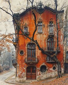 an old building with many windows and balconies on the front is surrounded by leaves