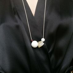 An interesting necklace in soft colors, which is infinitely adjustable in length.  The following gemstones slide on the cream-colored cord:  Garnet (dark red) - Porcelain (large white ball) - Citrine (yellow) - Magnesite (gray marbled)  Please note that especially the citrine and magnesite (often called howlite) will differ in shape and color from the product photos! Minimalist Long White Necklace, Minimalist White Long Necklace, Modern White Pendant Jewelry, White Jewelry With Natural Stones, Everyday White Jewelry With Natural Stones, Unique White Long Necklace, Minimalist White Jewelry With Natural Stones, Unique White Adjustable Necklace, Modern White Necklaces For Everyday