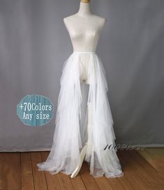 a white tulle skirt on a mannequin headdress with the words, 70 colors any size