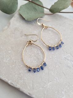 Dainty and sweet Blue Kyanite gemstone hoop earrings. These are super light and easy to wear! The blue of the Kyanite is such a gorgeous blue! These are perfect for the minimalist that wants just a little pop of color. Each circle is formed into an organic circle shape by hand. No two will be exactly alike. It is hammered for texture and shape. Gemstones are wire wrapped to the circle. The earrings are just about 1 1/4in. in length. Each piece is handmade and may vary slightly as well as the sto Cheap Blue Wire Wrapped Hoop Earrings, Blue Nickel-free Hoop Earrings For Everyday, Blue Small Hoop Earrings Wire Wrapped, Blue Small Hoop Earrings With Wire Wrapping, Blue Wire Wrapped Hoop Earrings As Gift, Blue Wire Wrapped Hoop Earrings For Gift, Blue Teardrop Hypoallergenic Hoop Earrings, Blue Dainty Hypoallergenic Hoop Earrings, Everyday Blue Teardrop Hoop Earrings