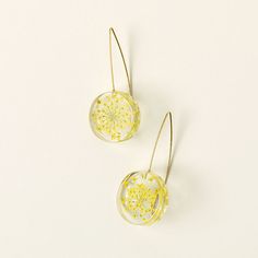 Queen Anne's lace frequently stars in wildflower bouquets, thanks to its vintage romantic vibe. Bring its sweet charm to your everyday with Tulianna and Alejandra Garces' earrings. Artisans handpick and preserve the blossoms, dye them bright yellow, set them in plant-baed resin, and hang them from gold-plated ear wires to spark sunny, natural joy all day long. Handmade in Colombia. Wildflower Bouquets, Uncommon Goods, Real Queens, Queen Anne's Lace, Ray Of Sunshine, Wildflower Bouquet, Queen Annes Lace, Queen Anne, Flower Earrings