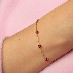 Our 14K Gold Evil Eye Bracelet is a blend of style and symbolism, inspired by the cultural heritage of the Turkish evil eye. This dainty bracelet, available exclusively in gold, features a choice of a blue or red evil eye charm, each known for its protective properties and cultural significance. The bracelet's delicate cable chain, with a thickness of 0.85 mm, is perfect for a subtle yet fashionable look and ideal for layering with other pieces. The adjustable length, ranging from 6.3" to 7.5", ensures a comfortable and versatile fit for various wrist sizes. Key Features: Cultural Symbol: Features a blue or red Turkish evil eye charm, known for its protective qualities and cultural significance. Delicate Design: Crafted with a slender cable chain, perfect for layering and versatile styling Dainty Yellow Gold Bracelet With Evil Eye Detail, Dainty Yellow Gold Bracelet With Evil Eye, Red 14k Gold Dainty Bracelet, Gift Red 14k Gold Bracelet, Red Evil Eye Jewelry, Gold Evil Eye Bracelet, Red Evil Eye, Turkish Evil Eye, Evil Eye Protection