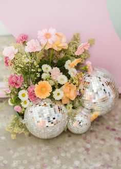 flowers and disco balls are sitting on the floor