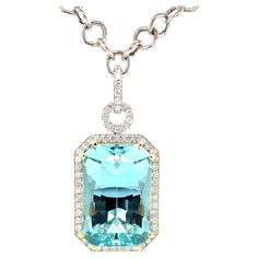 This stunning necklace features a magnificent 51.47 carat emerald-cut aquamarine with extraordinary blue color! The gem is surrounded by fine diamonds in an original pendant that is beautiful from every angle. The aquamarine is a perfectly proportioned "modified brilliant cut," with a rectangular outline and diamond-shaped facets that give this gemstone superior brilliance and life! We set this gorgeous blue gem in 18k yellow gold with double prongs and a custom designed 18k yellow gold basket. Gold Basket, Artisan Necklace, Gold Statement Necklace, Emerald Pendant, Elegant Pendant, Blue Gems, Modern Necklaces, Emerald Stone, Tennis Bracelet Diamond