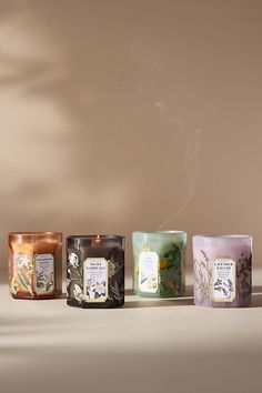 Adorned with beautiful botanicals, this *only-at-Anthro* fragrance lends everyday elegance to any living space - *and* is perfectly giftable for the scent-obsessed. Sol Tobac (Floral Gourmand): An enticing aroma of sun-kissed bergamot and a soft hint of white flowers gently dances atop a warm base of tobacco and vanilla. *For the best burn experience, keep the following in mind:* * The first time you light your candle, allow it to burn until the wax pool melts all the way to the edge; for a larg Candle Set Packaging, Green Candle Aesthetic, Scented Candles Packaging, Luxury Candles Packaging, Candle Product Photography, Iridescent Candle, Candle Glass Jar, Candle Luxury, Candle Design