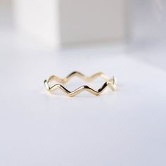 A dainty gold ring with zig zag pattern. A stacking gold ring for women, minimal and simple that adds glam to every outfit. This stacking wavy band can be used a an alternative wedding band as well. The best Christmas gift. 100% handcrafted with love!D E T A I L S● Metal: 14K solid gold, 14K white gold or 14K rose goldR I N G ∙ S I Z I N GFor General Reference:● we use standard US Ring Sizing● an average women's ring finger is size 6-7● each ring is custom made upon order, in any desired size.● Minimalist 14k Gold Wavy Jewelry, Minimalist 14k Gold Wavy Ring, Yellow Gold Wavy Ring For Anniversary, Everyday Yellow Gold Wavy Jewelry, Adjustable Wavy Stackable Jewelry, Elegant Yellow Gold Wavy Rings, Adjustable Stackable Wavy Jewelry, Anniversary Yellow Gold Wavy Rings, Wavy Yellow Gold Anniversary Rings