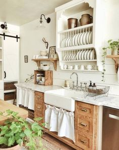 the kitchen is clean and ready to be used for cooking or baking, with dishes stacked on shelves above the sink