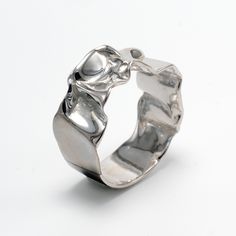 "There is beauty everywhere if you are ready to discover it, I thought looking at a crumpled piece of paper. This was the image that inspired the creation of this organic ring which was created with a delicate handmade wax modeling work. The result is a unique silver ring with a contemporary design of crumpled metal. The ring's design is ideal for both men and women, and would make a great wedding band as well. SEE THE ACTUAL RING IN 360 DEGREE VIDEO ON OUR YOUTUBE CHANNEL - https://youtu.be/lUe Crumpled Piece Of Paper, Mens Gold Band, Statement Rings Unique, Unique Gold Rings, Unique Wedding Band, Unique Silver Rings, Silver Wedding Band, Sterling Silver Wedding Band, Organic Rings