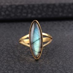 Large Labradorite Marquise ring, women ring, handmade ring, Dainty ring, Statement ring, Promise ring, vintage ring, boho ring, Anniversary ring, wedding gift, gift ring, gift for her METAL :- Brass Finish :- gold STONE :- Labradorite STONE SIZE :- 8/20 MM We Crafted These in 100% Solid Silver and Brass These Simple rings are perfect for any occasion. ~ Make a Statement with these minimal yet simple Unique Rings. Ring can be customized on request and gemstone can be made to any gemstone you want Unique Gold Labradorite Rings, Dainty Rings With Natural Stones For Gift, Dainty Rings With Natural Stones As Gifts, Handmade Moonstone Toe Ring As A Gift, Marquise Gemstone Stackable Rings Gift, Toe Ring With Natural Stones For Gift, Dainty Marquise Ring For Gift, Marquise Gemstone Crystal Ring Gift, Elegant Adjustable Labradorite Ring