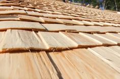 wood planks are stacked on top of each other in order to be used for roofing