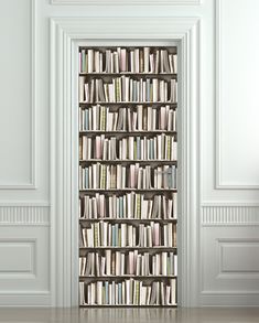 an open bookcase with many books on it in front of a white wall and floor