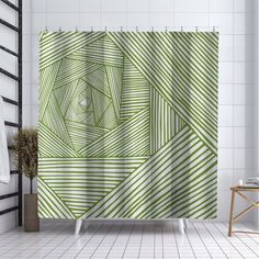 a bathroom with a shower curtain that has an abstract design on the front and side