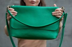 If you need a large everyday shoulder bag, look at this one. You will like this emerald green leather bag as soon as you hold it in your hands. The size is optimal for everyday use. Closing with a metal zipper is very reliable. You can use a crossbody purse with a short handle or with a long handle. Vivid green shoulder bag will be a bright addition to your look. The minimalist design will look great with clothes of different styles. HIGH QUALITY LEATHER Vivid green shoulder bag is made of high quality 100% genuine leather. The leather is soft and pleasant to use. The structure and relief of the leather is very natural. This minimalist bag practical and completely handmade, so each seam is securely fastened. The bottom of the bag is reinforced with an additional layer of leather. Therefore Green Leather Bag, Everyday Shoulder Bag, Green Shoulder Bag, Green Minimalist, Minimalist Bag, Everyday Bag, Metal Zipper, Green Leather, Crossbody Purse