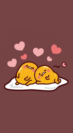 two yellow eggs laying on top of each other with hearts floating above them in the air